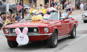Antique cars — this one a red convertible — participate in the Easter Parade in St. Augustine. Photo by Jackie Hird.