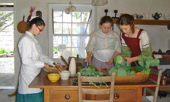 Boarding house staff preparing the meal. 