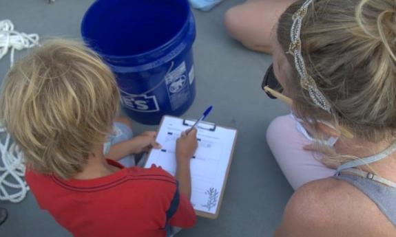 A budding scientist recording data on Florida Water Warriors Community Science Tour in St. Augustine.