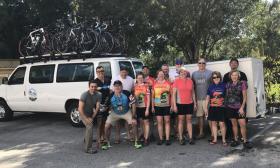 A Greenway cyclist group, posing by the support van. 