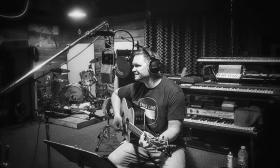 Matt Fowler playing music in a recording studio