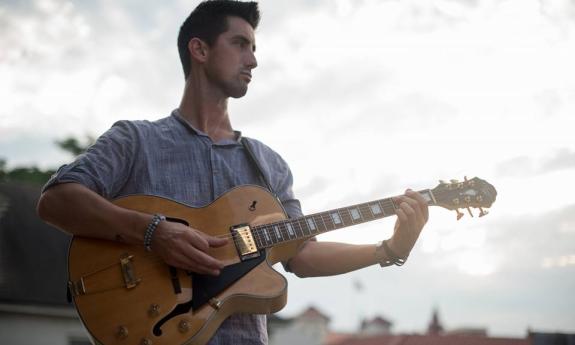 Ian Kelly with his guitar