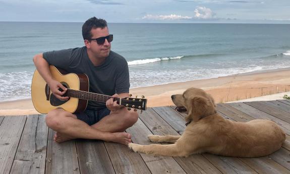 Ian Opalinski playing for a rapt audience of one canine in St. Augustine.