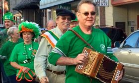Patrick O'Flaherty leading a St. Patrick's Day promenade with his button accordion.
