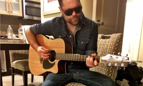 Jared Mullins with his guitar