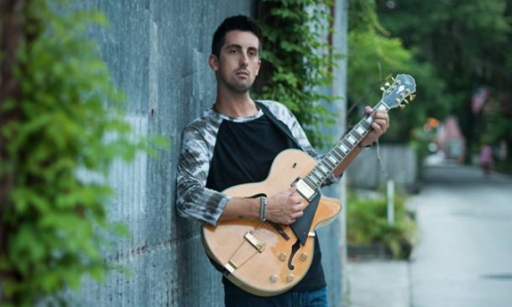 Ian Kelly with his guitar