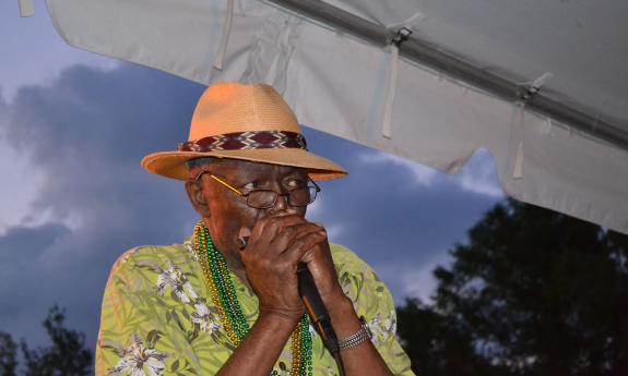 Willie Green playing his harmonica 