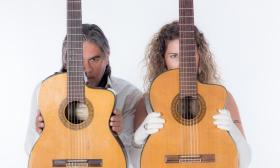 Gabriel Hermida and Yael Dray, of Yael and Gabriel, with two guitars.