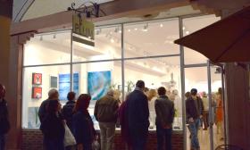 First Friday Art Walk visitors stop by the Plum Gallery in its new location.