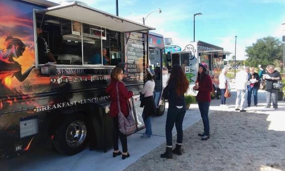 Customers waiting in line outside the food truck