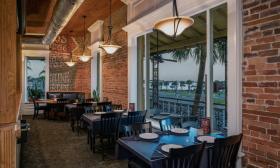 Indoor seating with a view to the Bayfront at A1A Ale Works.