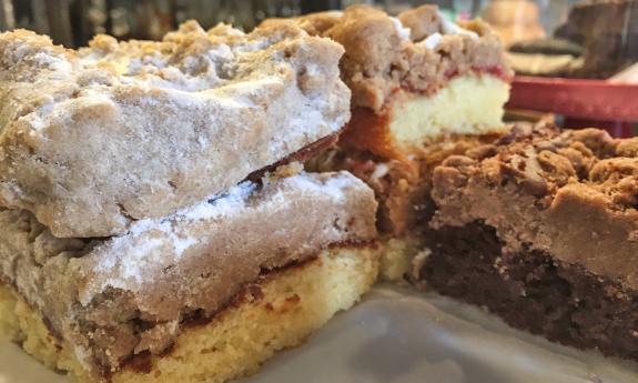 Baked goods decorate the counter, including this sour cream and apple crumb cake.