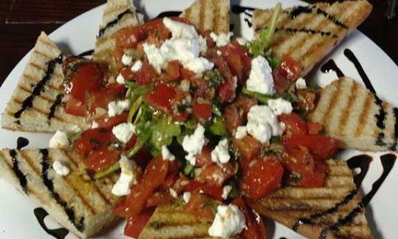 The Press offers delicious starters, like the Tomato Hummus Bruschetta.