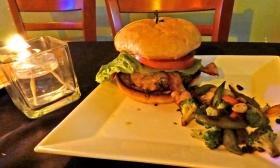 Bacon Cheddar Burger with roasted vegetables at Tempo Restaurant in St. Augustine.