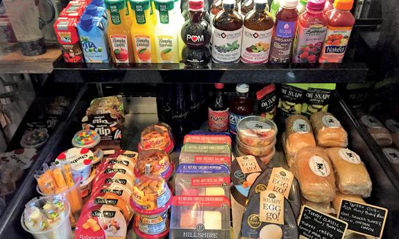 Convenience snacks and drinks are available and are sitting in a fridge display.