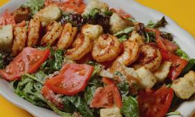 Blackened Shrimp on a mixed green salad is served at Gypsy Cab in St. Augustine.