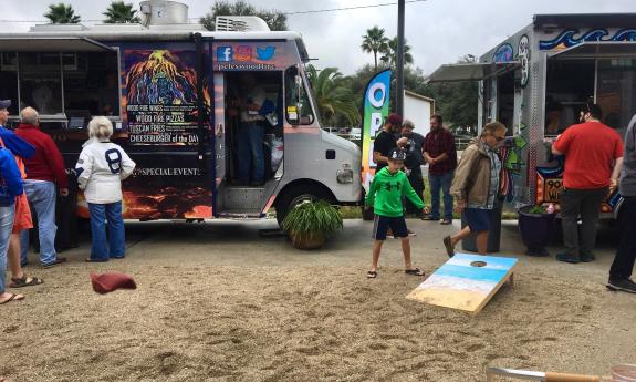 Play corn hole at Village Garden Food Truck Park in St. Augustine, Florida