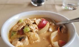 Bowl of Thai soup with chicken and vegetables