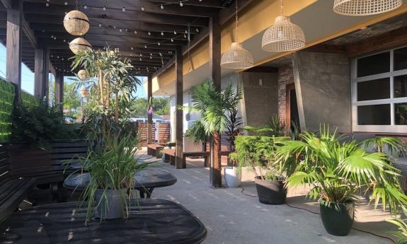 The outdoor dining space with greenery surrounding it