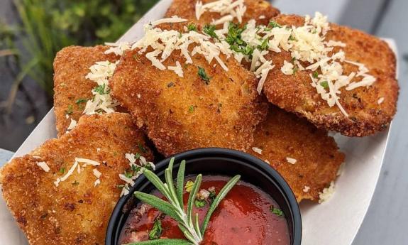 Fried ravioli bites served with marinara sauce on the side