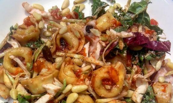 A tortellini pasta salad with pine nuts dish