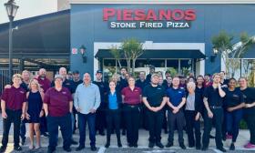 The Piesanos Stone Fired Pizza team in St Augustine's Cobblestone Village ready to greet visitors.
