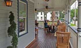 The outdoor seating area on the porch of Preserved Restaurant in the historic Lincolnville district in St. Augustine, Florida.