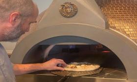 The chef prepares wood oven pizza at Simone's Wood Fired Craft Kitchen in St. Augustine, FL.