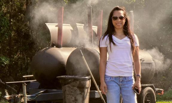 Sweet Smokey's BBQ smoker with a happy customer in Hastings, west of St. Augustine.