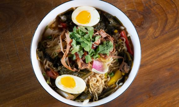 Uptown Swinery ramen bowl with a sesame ginger broth layered with smoked pork and collard greens in St. Augustine..