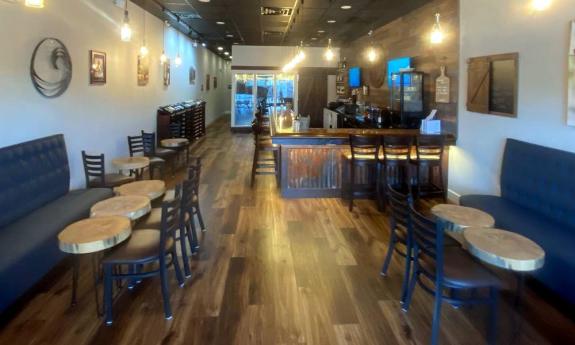 The bar and tables in the relaxing interior of Southern Vibes Tasting Room and Wine Cellar at Murabella Crossing in St. Augustine.