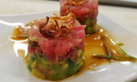 Tuna tartare tower with fresh guacamole, crispy shallots, and an Asian-inspired dipping sauce at St. Augustine's Elkhouse Eatery.