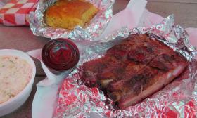 A plate with ribs, coleslaw, and Datil pepper cornbread
