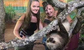 Zookeepers enjoy the company of one of the Alligator Farm's Hoffman's two-toed sloths in a brand new exhibit.