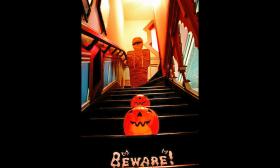 The stairway of Villa Zorayda decorated with Halloween pumpkins and a mummy.