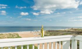 Enjoy a glass of wine and the ocean from your balcony at Saint Augustine Beach House 