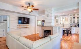 The wood-paneled “Romantic Getaway” property in historic downtown St. Augustine is furnished with a white interior and a full kitchen