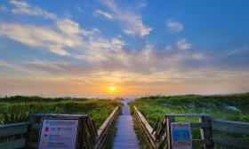 The view of sunrise over the boardwalk at Guy Harvey Resort St. Augustine Beach.