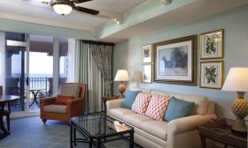 Living room and balcony in Suite at Hammock Beach Golf Resort & Spa