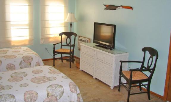 The first floor bedroom features two twin beds and a pullout couch.