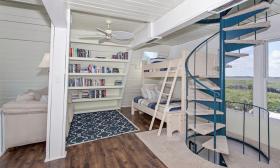 Unique features like a spiral staircase and built-in bookshelf lend charm to the Captain's Cottage.