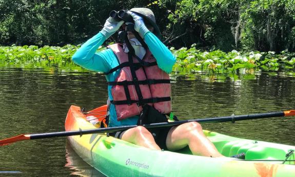 A kayaker birdwatching on a Geo Trippin' adventure from Trout Creek.