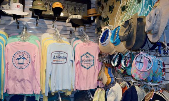 Shirts and hats on display inside the shop