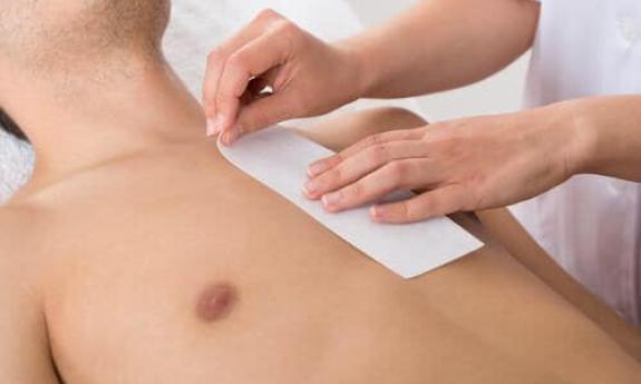 Man getting his chest waxed