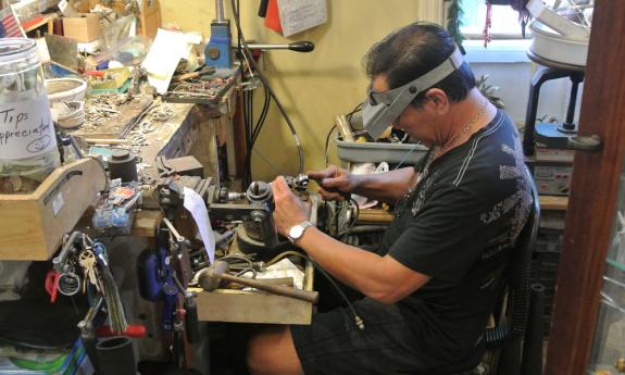 Hung Chau repairing a piece of jewelry