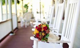 The Cedar House Inn's wrap-around porch with wedding bouquet.