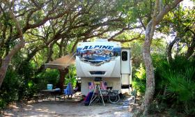 An RV in one of the camping spots at North Beach Camp Resort in St. Augustine, Florida