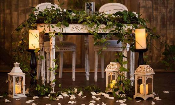 Table and chairs with candles and decor on display at St. Augustine's Carriage House.