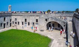 Visitors explore all rooms, made out of coquina, inside the fort