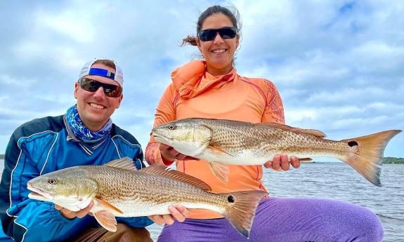 A couple celebrates their catch of the day in St. Augustine.